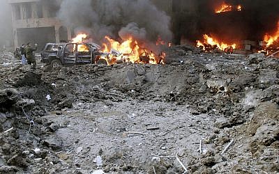 A crater formed after a car bomb targeting the motorcade of Lebanon's most prominent politician, former Lebanese prime minister Rafik Hariri, is seen in Beirut, Lebanon, Feb. 14, 2005. (AP Photo)