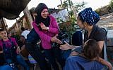 Illustrative: Israeli Jews and Palestinians talk to each other during a coexistence meeting in the West Bank, on July 22, 2015 (Nati Shohat/Flash90)