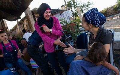 Illustrative: Israeli Jews and Palestinians talk to each other during a coexistence meeting in the West Bank, on July 22, 2015 (Nati Shohat/Flash90)