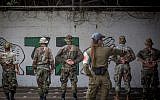 A military police officer speaks with imprisoned Israeli soldiers at Prison Four, Israel's largest military prison, located at the Tzrifin military base on Aril 26, 2018. (Miriam Alster/FLASH90)