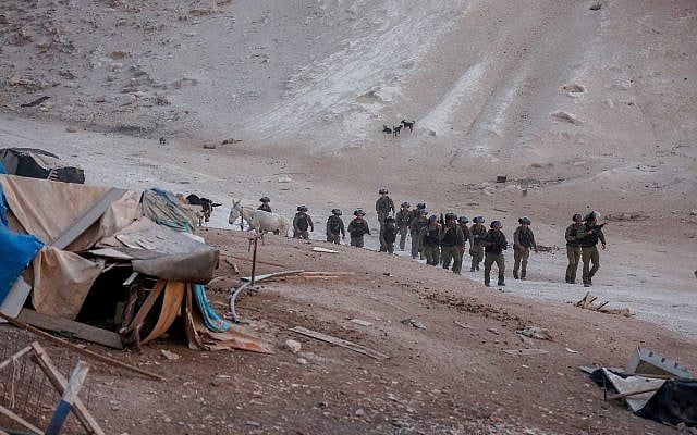 Israeli security forces seen during the demolition of protest trailers near the Bedouin village of Khan al-Ahmar in the West Bank on September 13, 2018. (Wisam Hashlamoun/Flash90) Israeli security forces seen during the demolition of protest trailers near the Bedouin village of Khan al-Ahmar in the West Bank on September 13, 2018. (Wisam Hashlamoun/Flash90)