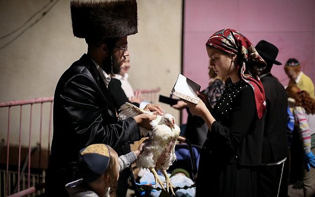 Ultra-Orthodox Jews perform the kaparot ritual on September 16, 2018, in the Northern Israeli city of Tzfat. (David Cohen/Flash90) Ultra-Orthodox Jews perform the kaparot ritual on September 16, 2018, in the Northern Israeli city of Tzfat. (David Cohen/Flash90)