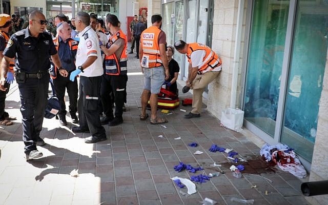Medics arrive on the scene after an Israeli man was stabbed in a terrorist attack at a shopping mall next to the Gush Etzion Junction on September 16, 2018. (Gershon Elinson/FLASH90) Medics arrive on the scene after an Israeli man was stabbed in a terrorist attack at a shopping mall next to the Gush Etzion Junction on September 16, 2018. (Gershon Elinson/FLASH90)