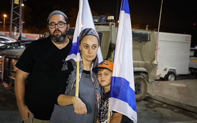 People light candles in memory of Ari Fuld, at the site where he was murdered, at the Gush Etzion Junction, September 16, 2018. (Gershon Elinson/FLASH90) People light candles in memory of Ari Fuld, at the site where he was murdered, at the Gush Etzion Junction, September 16, 2018. (Gershon Elinson/FLASH90)