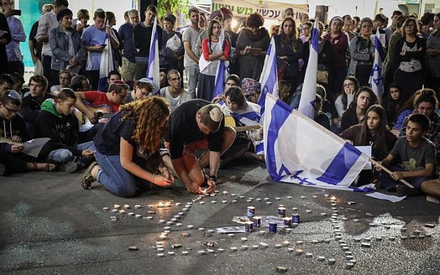 People light candles in memory of Ari Fuld, at the site where he was murdered at the Gush Etzion Junction, September 16, 2018. (Gershon Elinson/FLASH90) People light candles in memory of Ari Fuld, at the site where he was murdered at the Gush Etzion Junction, September 16, 2018. (Gershon Elinson/FLASH90)