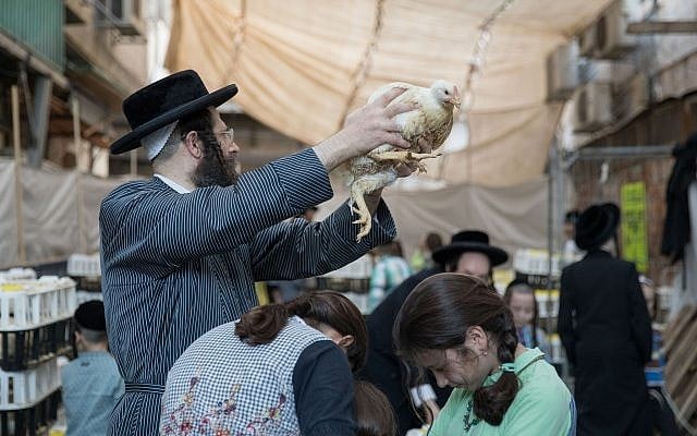 Ultra Orthodox Jews perform the kaparot ritual on September 16, 2018, in the ultra orthodox neighborhood of Me'a Shearim, in Jerusalem. (Noam Revkin Fenton/Flash90) Ultra Orthodox Jews perform the kaparot ritual on September 16, 2018, in the ultra orthodox neighborhood of Me'a Shearim, in Jerusalem. (Noam Revkin Fenton/Flash90)
