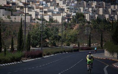 Israelis ride their bicycles along the empty road in Jerusalem on Yom Kippur, September 19, 2018 (Hadas Parush/Flash90)