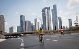 Israelis ride their bicycles along the empty Ayalon highway in Tel Aviv, on Yom Kippur, September 19, 2018 (Miriam Alster/Flash 90)