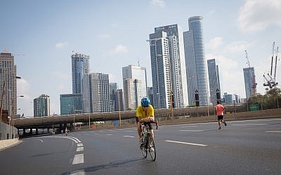 Israelis ride their bicycles along the empty Ayalon highway in Tel Aviv, on Yom Kippur, September 19, 2018 (Miriam Alster/Flash 90)