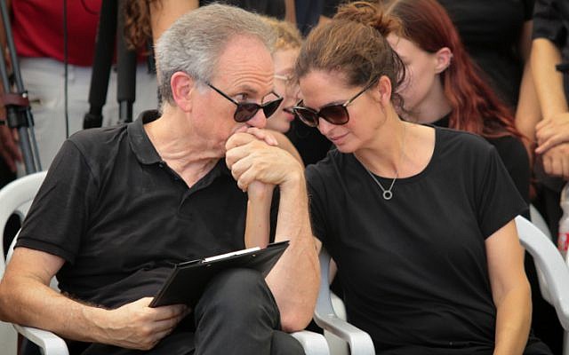 Iris and Avi (L) Nesher mourn during the funeral of their son 17-year-old Ari Nesher in Moshav Udim cemetery, Sunday, September 30, 2018. (Roy Alima/Flash90)