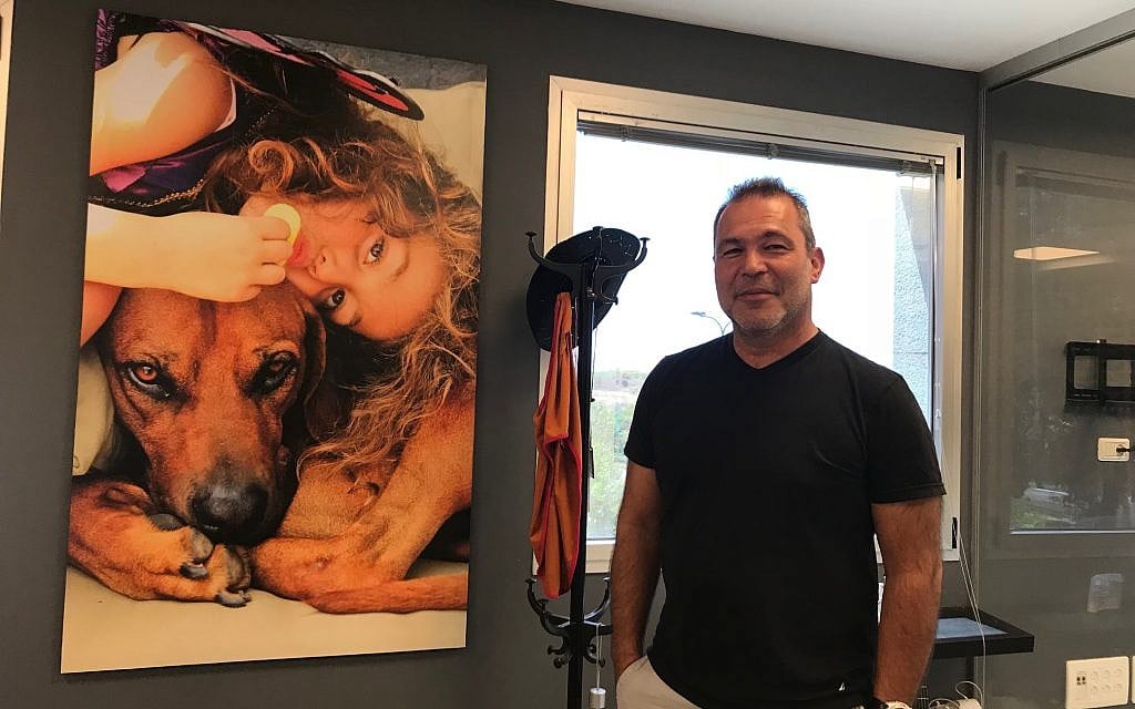 Zvi Frank, a former pilot in the Israeli Air Force, and now the CEO of the startup Zemingo, at his office in Herzliya; in the background is a poster of his daughter with his do,. August 20, 2018 (Shoshanna Solomon; Times of Israel) Zvi Frank, a former pilot in the Israeli Air Force, and now the CEO of the startup Zemingo, at his office in Herzliya; in the background is a poster of his daughter with his do,. August 20, 2018 (Shoshanna Solomon; Times of Israel)