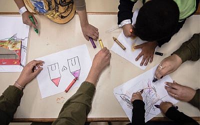 Syrian children color inside a facility run by the army's 'Operation Good Neighbor' project, which helped thousands of Syrians before Israel shut it down after Syrian dictator Bashar Assad took control of the area bordering the Golan Heights. (Israel Defense Forces)