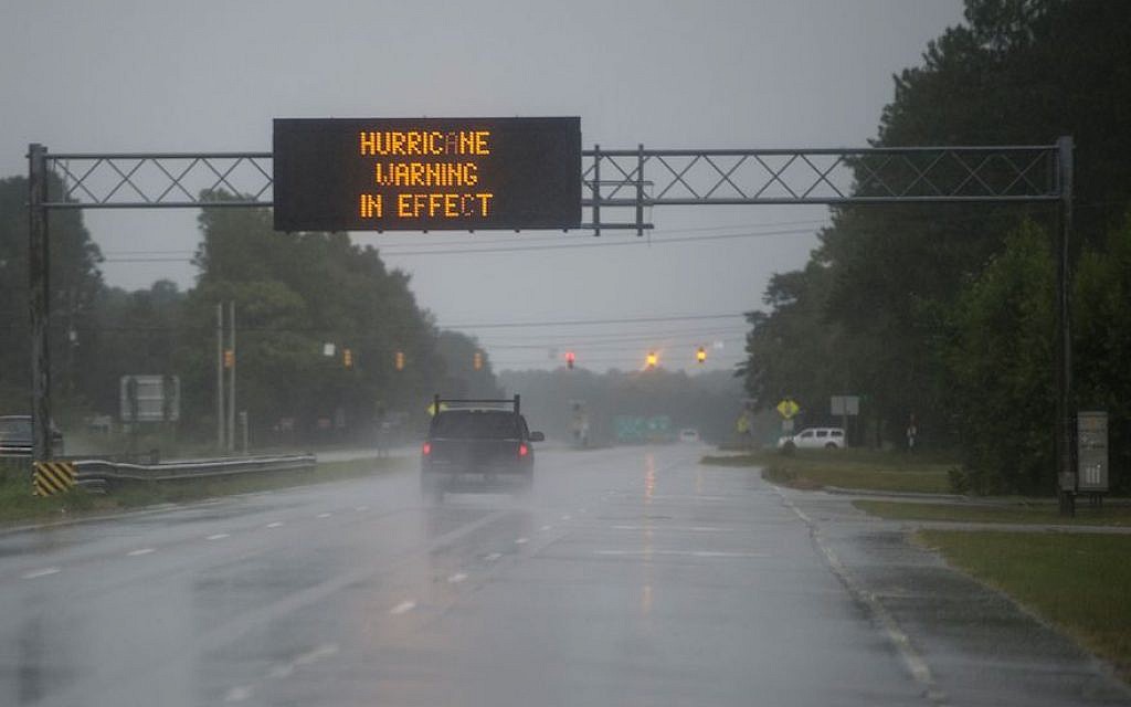 Cars drive on a wet road as rain from Hurricane Florence falls in Wilmington, North Carolina, September 13, 2018. (Andrew Caballero-Reynolds/AFP/Getty Images) Cars drive on a wet road as rain from Hurricane Florence falls in Wilmington, North Carolina, September 13, 2018. (Andrew Caballero-Reynolds/AFP/Getty Images)