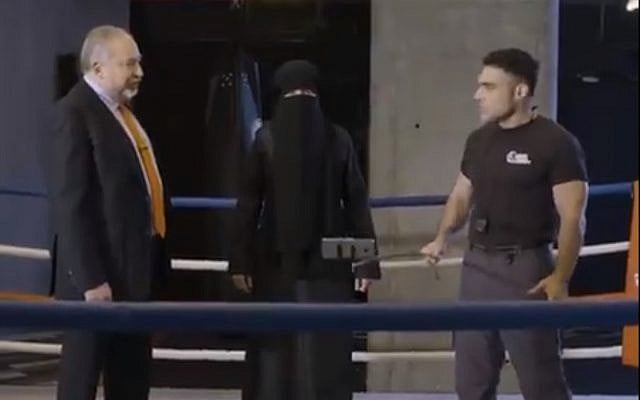 Defense Minister Avigdor Liberman, left, pretends to learn self defense in a Rosh Hashanah greeting released on September 4, 2018. (Screen capture: Twitter) Defense Minister Avigdor Liberman, left, pretends to learn self defense in a Rosh Hashanah greeting released on September 4, 2018. (Screen capture: Twitter)