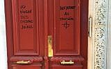 Anti-Semitic graffiti reading 'Jewish scum live here,' on a building in Paris. 'Notably on the third floor,' it adds on the other side of the door, above a drawing of a target. (Twitter)