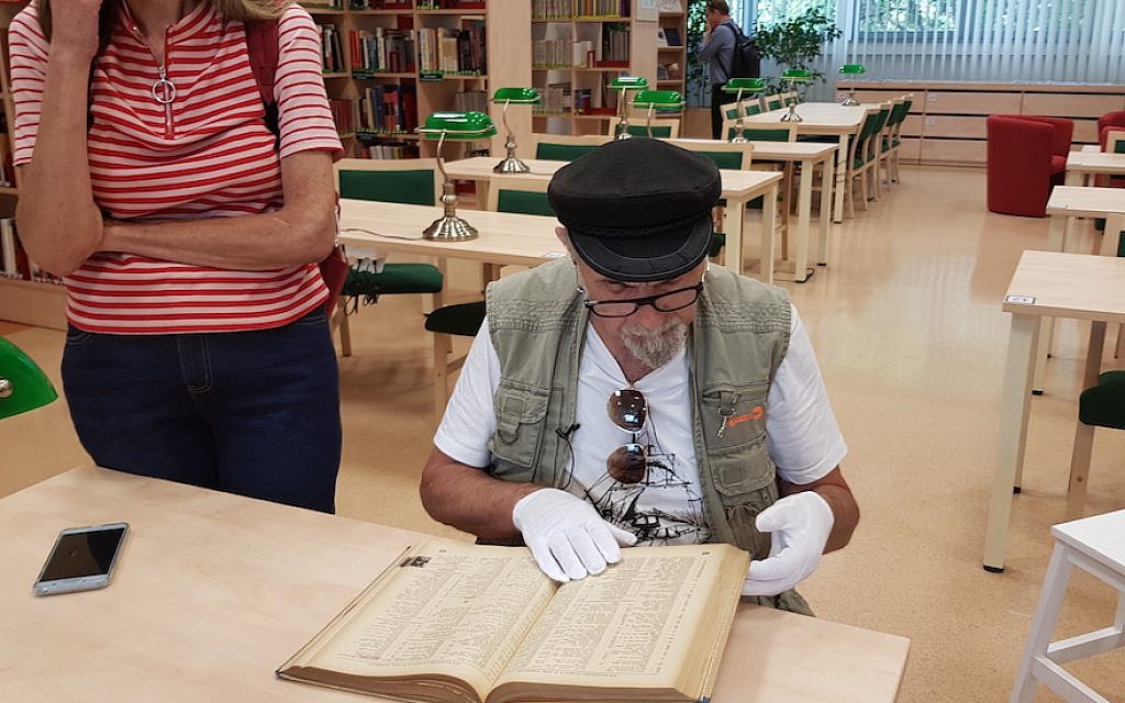 Yoram Sztykgold examines the unpublished registry from 1939 that helped him locate his family’s assets at a military library in Warsaw, Sept. 4, 2018. (Cnaan Liphshiz) Yoram Sztykgold examines the unpublished registry from 1939 that helped him locate his family’s assets at a military library in Warsaw, Sept. 4, 2018. (Cnaan Liphshiz)