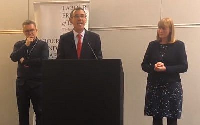 Israel ambassador to the UK Mark Regev (c) addresses a 2018 Labour Friends of Israel meeting, flanked by Labour party deputy leader Tom Watson (l) and LFI chair Joan Ryan. (Screen capture: Twitter)