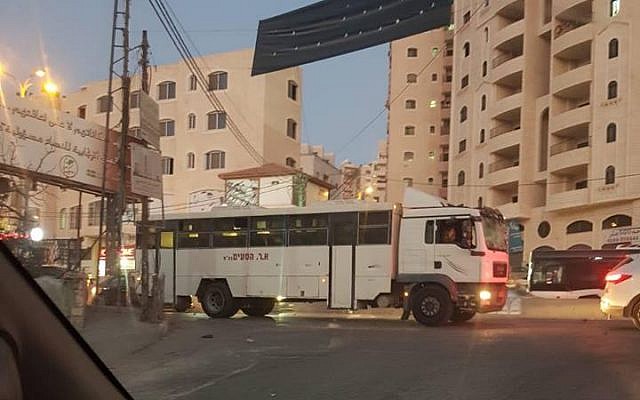 An Israeli military bus after it accidentally entered the Qalandiya refugee camp north of Jerusalem in the central West Bank on September 16, 2018. (Twitter) An Israeli military bus after it accidentally entered the Qalandiya refugee camp north of Jerusalem in the central West Bank on September 16, 2018. (Twitter)