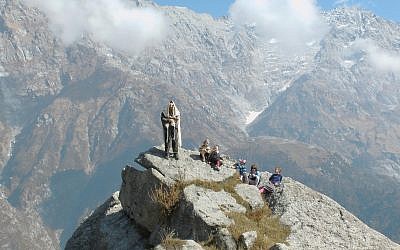 Rabbi Dror Shaul prays with his children in the Himalayan mountains near his Chabad centers close to Dharamshala. (Courtesy)