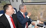 Prime Minister Benjamin Netanyanu (r) and Transportation and Information Minister Yisrael Katz ride the inaugural high-speed train from Jerusalem to Ben Gurion airport on September 20, 2018. (Amos Ben-Gershom / GPO)