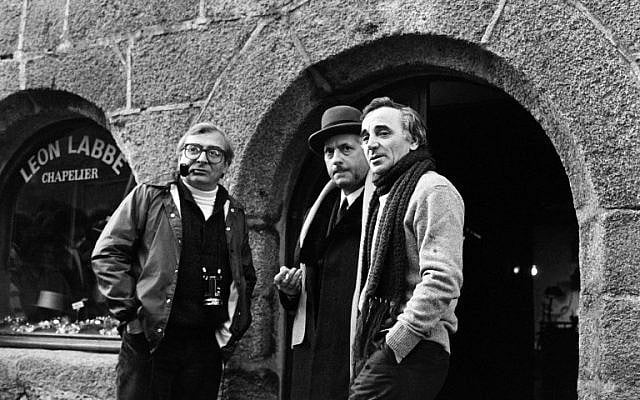 In this file photo taken on January 20, 1982 French singer-songwriter Charles Aznavour (R) talks with French actor Michel Serrault (C) and director Claude Chabrol in Concarneau, on the set of the film "Les fantome du chapelier". (AFP PHOTO / JEAN-PIERRE PREVEL)