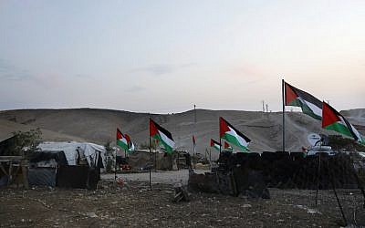 The Palestinian Bedouin village of Khan al-Ahmar, east of Jerusalem in the West Bank, is seen decorated with Palestinian flags on October 2, 2018. (AFP PHOTO / AHMAD GHARABLI)