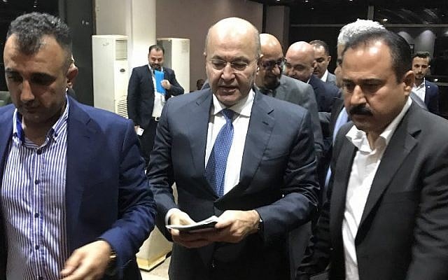 Newly elected Iraqi President Kurdish Barham Saleh (C) walks at the parliament in Baghdad on October 2, 2018. (AFP PHOTO / Karim AMMAR) Newly elected Iraqi President Kurdish Barham Saleh (C) walks at the parliament in Baghdad on October 2, 2018. (AFP PHOTO / Karim AMMAR)