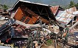 Rescue personnel search for earthquake survivors at a collapsed home in Balaroa, West Palu, Indonesia's Central Sulawesi on October 3, 2018. (YUSUF WAHIL/AFP)
