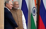 Russian President Vladimir Putin, left, and Indian Prime Minister Narendra Modi pose for photographers ahead of their meeting at Hyderabad House in New Delhi on October 5, 2018. (AFP Photo/Sputnik/Mikhail Klimentyev)