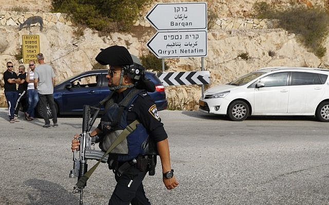 Israeli security forces gather at the site of a terror attack at the Barkan Industrial Park, near the northern West Bank settlement of Ariel, on October 7, 2018. (AFP Photo/Jack Guez)