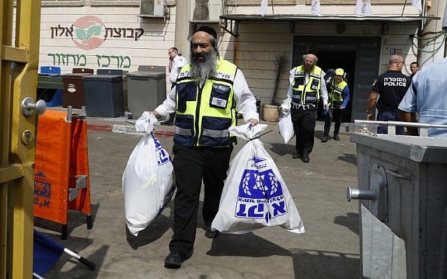 Emergency service volunteers at the site of a shooting attack at the Barkan Industrial Park in the northern West Bank on October 7, 2018. (AFP Photo/Jack Guez)