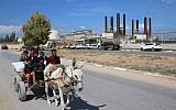 Palestinians ride a donkey near the Gaza power plant in Nuseirat, in the central Gaza Strip October 9, 2018. (AFP Photo/Said Khatib)