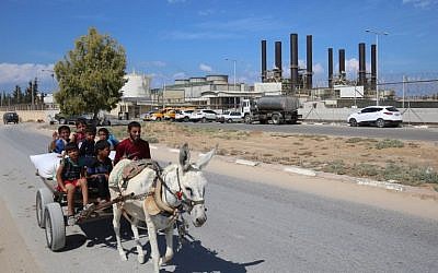 Palestinians ride a donkey near the Gaza power plant in Nuseirat, in the central Gaza Strip October 9, 2018. (AFP Photo/Said Khatib)