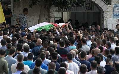 Palestinian carry the body of 48-year-old mother of eight, Aisha Rabi, who died of her wounds after the car she was travelling in with her husband was hit by stones, during her funeral in the West Bank village of Biddya, on October 13, 2018. (JAAFAR ASHTIYEH / AFP) Palestinian carry the body of 48-year-old mother of eight, Aisha Rabi, who died of her wounds after the car she was travelling in with her husband was hit by stones, during her funeral in the West Bank village of Biddya, on October 13, 2018. (JAAFAR ASHTIYEH / AFP)