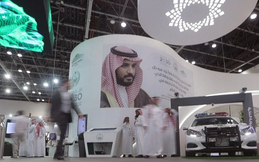 Illustrative: Saudis stand next to a portrait of Saudi Crown Prince Mohammed bin Salman at the Gitex 2018 exhibition at the Dubai World Trade Center in Dubai on October 16, 2018. (KARIM SAHIB / AFP) Illustrative: Saudis stand next to a portrait of Saudi Crown Prince Mohammed bin Salman at the Gitex 2018 exhibition at the Dubai World Trade Center in Dubai on October 16, 2018. (KARIM SAHIB / AFP)