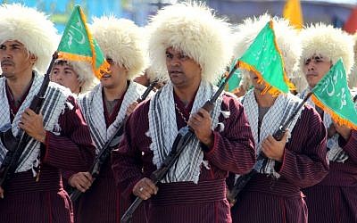 In this file photo taken on September 21, 2012, Turkmen Basij militiamen take part in an annual military parade marking the Iran-Iraq war, in the Iranian capital Tehran. (Atta Kenare/AFP)