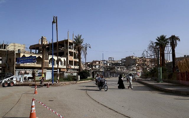 People drives their motorcycles in a street in the Syrian city of Raqqa on October 18, 2018. (Delil Souleiman/AFP)