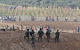 Israeli soldiers taking positions during clashes with Palestinian protesters across the Gaza border on October 19, 2018 near Nahal Oz. (Jack Guez/AFP)