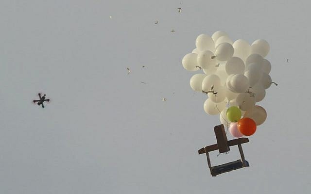 This picture taken on October 19, 2018, at Kibbutz Nahal Oz in southern Israel shows an Israeli military drone approaching balloons carrying an apparent incendiary device launched by Palestinians in the Gaza Strip. (Jack Guez/AFP) This picture taken on October 19, 2018, at Kibbutz Nahal Oz in southern Israel shows an Israeli military drone approaching balloons carrying an apparent incendiary device launched by Palestinians in the Gaza Strip. (Jack Guez/AFP)