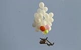Illustrative: This picture taken on October 19, 2018 in Nahal Oz, from the Israeli side of the border with the northeast of the Gaza Strip, shows balloons carrying an incendiary device launched by Palestinians. (Photo by JACK GUEZ / AFP)