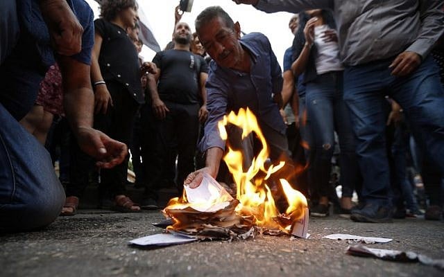 Druze residents of Majdal Shams in the Golan Heights set ablaze makeshift ballot papers during a protest on October 19, 2018. (Jalaa Marey/AFP) Druze residents of Majdal Shams in the Golan Heights set ablaze makeshift ballot papers during a protest on October 19, 2018. (Jalaa Marey/AFP)
