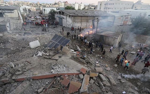 Palestinians gather by the rubble of a building in Gaza City destroyed by an Israeli airstrike on October 27, 2018. (Mahmud Hams/AFP)