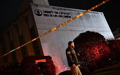 An FBI agent stands behind a police cordon outside the Tree of Life Synagogue after a shooting there left 11 people dead in the Squirrel Hill neighborhood of Pittsburgh on October 27, 2018. (Brendan Smialowski / AFP) An FBI agent stands behind a police cordon outside the Tree of Life Synagogue after a shooting there left 11 people dead in the Squirrel Hill neighborhood of Pittsburgh on October 27, 2018. (Brendan Smialowski / AFP)