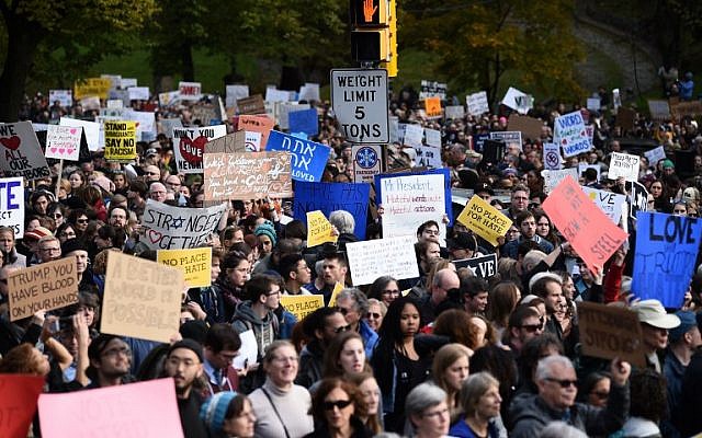 People gather to protest the arrival of US President Donald Trump as he visits the Tree of Life Congregation on October 30, 2018 in Pittsburgh, Pennsylvania. - Scores of protesters took to the streets of Pittsburgh to denounce a visit by US President Donald Trump in the wake of a mass shooting at a synagogue that left 11 people dead. Demonstrators gathered near the Tree of Life synagogue, where the shooting took place, holding signs that read "President Hate, Leave Our State!" and "Trump, Renounce White Nationalism Now." (Photo by Brendan SMIALOWSKI / AFP) People gather to protest the arrival of US President Donald Trump as he visits the Tree of Life Congregation on October 30, 2018 in Pittsburgh, Pennsylvania. - Scores of protesters took to the streets of Pittsburgh to denounce a visit by US President Donald Trump in the wake of a mass shooting at a synagogue that left 11 people dead. Demonstrators gathered near the Tree of Life synagogue, where the shooting took place, holding signs that read "President Hate, Leave Our State!" and "Trump, Renounce White Nationalism Now." (Photo by Brendan SMIALOWSKI / AFP)