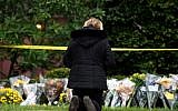 A mourner prays after laying flowers at the site of the mass shooting that killed 11 people and wounded 6 at the Tree Of Life Synagogue on October 28, 2018 in Pittsburgh, Pennsylvania.  (Jeff Swensen/Getty Images/AFP)