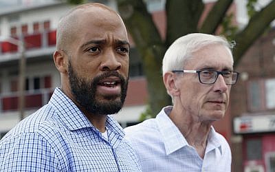 In this photo from August 15, 2018, Wisconsin Democratic lieutenant governor candidate Mandela Barnes, left, and governor candidate Tony Evers speak to reporters at a news conference in Madison, Wisconsin. (Michelle Stocker/The Capital Times via AP)