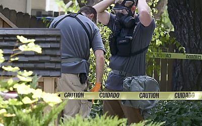 Law enforcement officers search a house on Wednesday, Oct. 3, 2018, in Logan, Utah. A man suspected of mailing ricin to the Pentagon and President Donald Trump was taken into custody at the scene. (Eli Lucero/Herald Journal via AP)