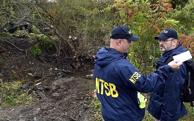 Debris scatters an area Sunday, Oct. 7, 2018, at the site of the fatal crash Schoharie, N.Y. (AP Photo/Hans Pennink)