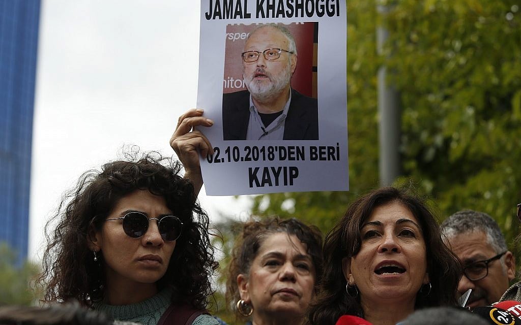 Activists, members of the Human Rights Association Istanbul branch, holding posters with photos of missing Saudi journalist Jamal Khashoggi, talk to members of the media, during a protest in his support near the Saudi Arabia consulate in Istanbul, October 9, 2018. (AP Photo/Lefteris Pitarakis)