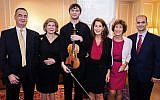 In this photo provided by Chris Lee, Juilliard student Nathan Meltzer, center, poses with the "Ames, Totenberg" Stradivari of 1734 violin loaned to him by the daughters of the late violinist Roman Totenberg, October 9, 2018 in New York. (Chris Lee via AP)